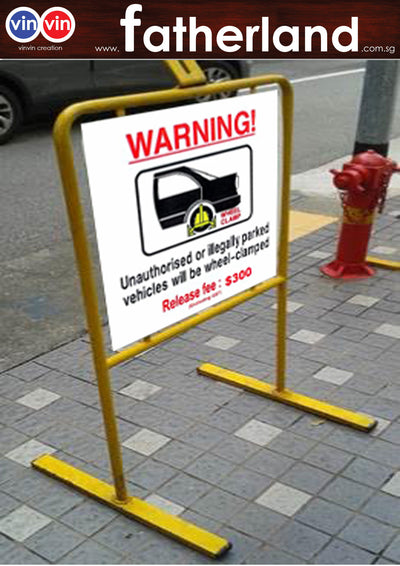 WARNING UNAUTHORISED OR ILLEGALLY PARKED VEHICLE WILL BE WHEEL CLAMPED WITH STANDS